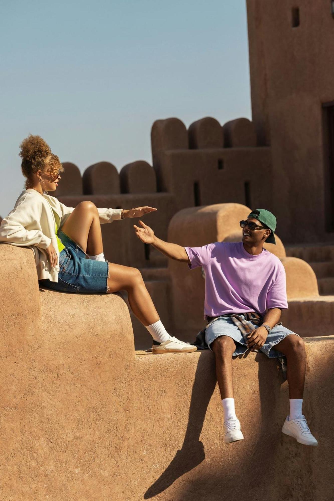 W Muscat Hotel Exterior foto Two people greeting each other with a high five